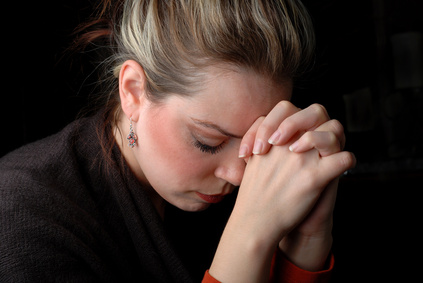 a woman is praying to god with hope (humility)
